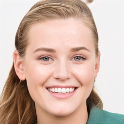 Joyful white young-adult female with long  brown hair and blue eyes