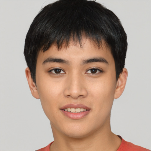 Joyful asian young-adult male with short  brown hair and brown eyes