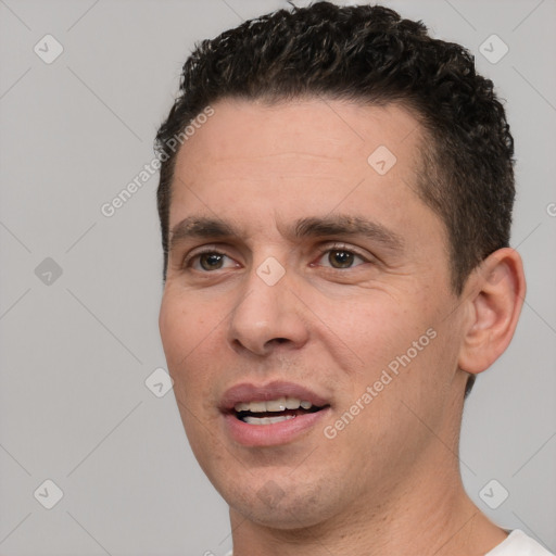 Joyful white adult male with short  brown hair and brown eyes