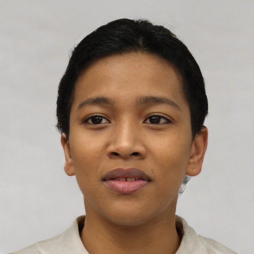 Joyful latino young-adult female with short  black hair and brown eyes