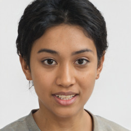 Joyful latino young-adult female with short  black hair and brown eyes