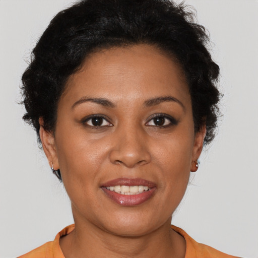Joyful latino young-adult female with short  brown hair and brown eyes