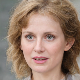 Joyful white young-adult female with medium  brown hair and blue eyes