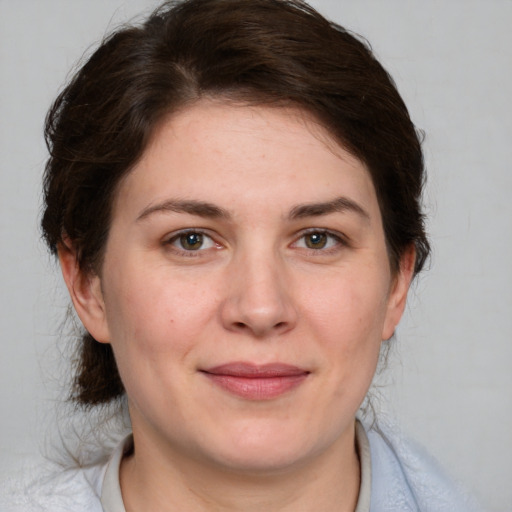 Joyful white adult female with medium  brown hair and brown eyes