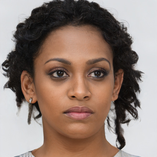 Neutral black young-adult female with medium  brown hair and brown eyes