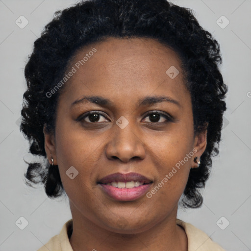 Joyful black young-adult female with short  black hair and brown eyes