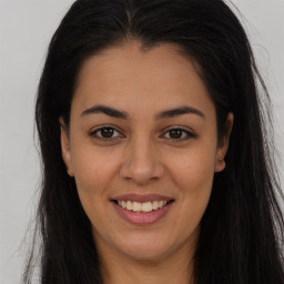 Joyful latino young-adult female with long  brown hair and brown eyes