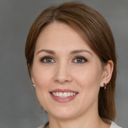 Joyful white young-adult female with medium  brown hair and grey eyes