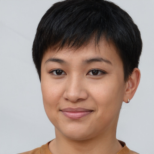 Joyful asian young-adult female with short  brown hair and brown eyes