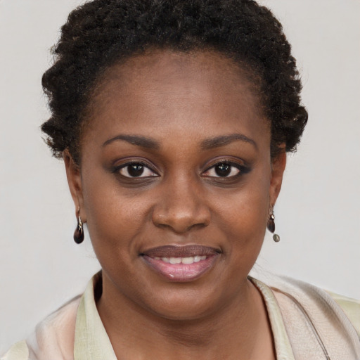 Joyful black young-adult female with short  brown hair and brown eyes