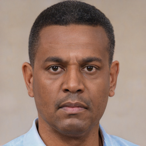Neutral black adult male with short  black hair and brown eyes