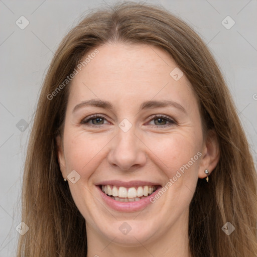 Joyful white adult female with long  brown hair and grey eyes