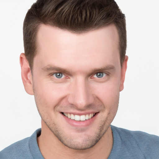 Joyful white young-adult male with short  brown hair and grey eyes