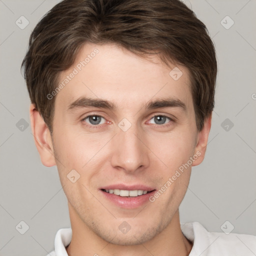 Joyful white young-adult male with short  brown hair and grey eyes