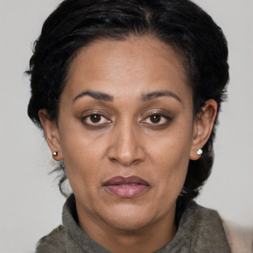 Joyful black adult female with short  brown hair and brown eyes