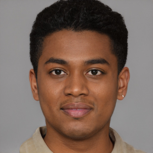 Joyful black young-adult male with short  black hair and brown eyes