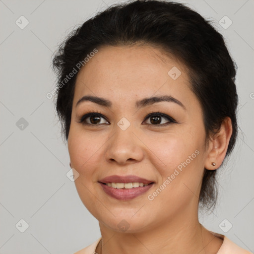 Joyful latino young-adult female with medium  brown hair and brown eyes