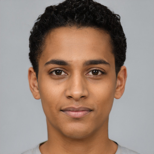 Joyful latino young-adult male with short  brown hair and brown eyes