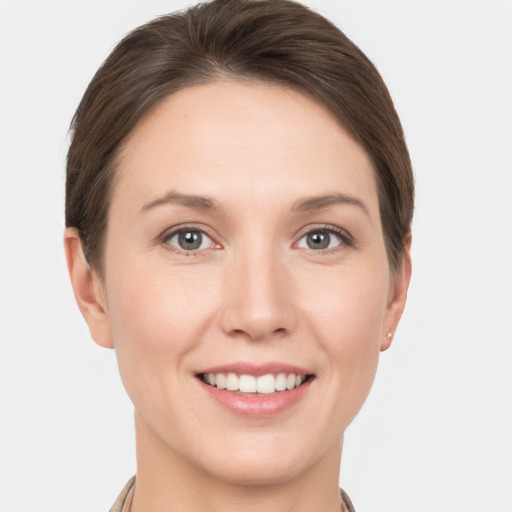 Joyful white young-adult female with short  brown hair and grey eyes