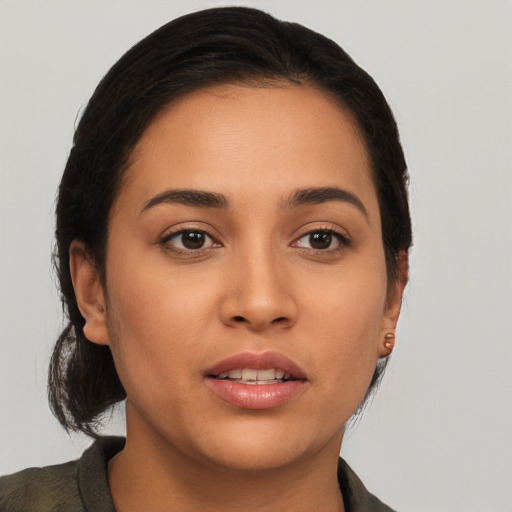 Joyful latino young-adult female with long  brown hair and brown eyes