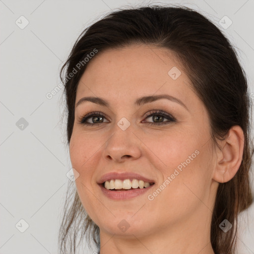 Joyful white young-adult female with long  brown hair and brown eyes