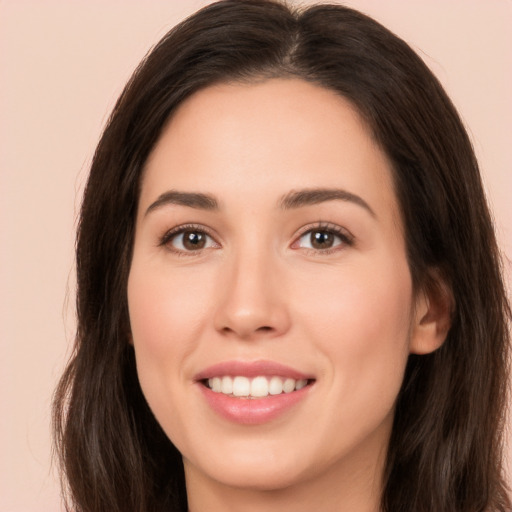 Joyful white young-adult female with long  brown hair and brown eyes