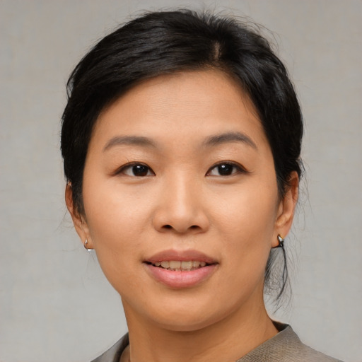 Joyful asian young-adult female with medium  brown hair and brown eyes
