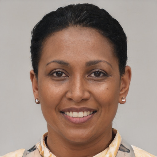 Joyful latino adult female with short  black hair and brown eyes