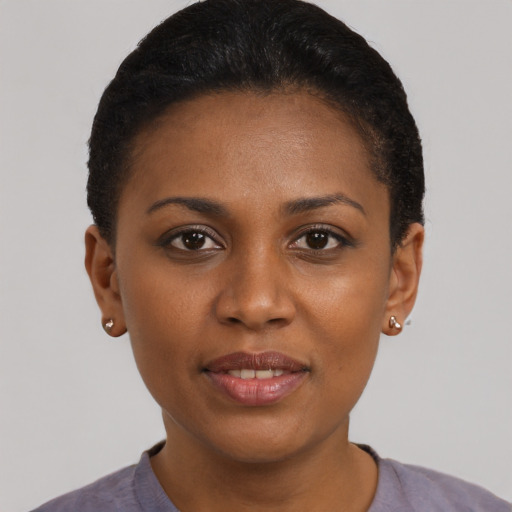 Joyful black young-adult female with short  brown hair and brown eyes