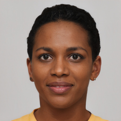 Joyful black young-adult female with short  black hair and brown eyes