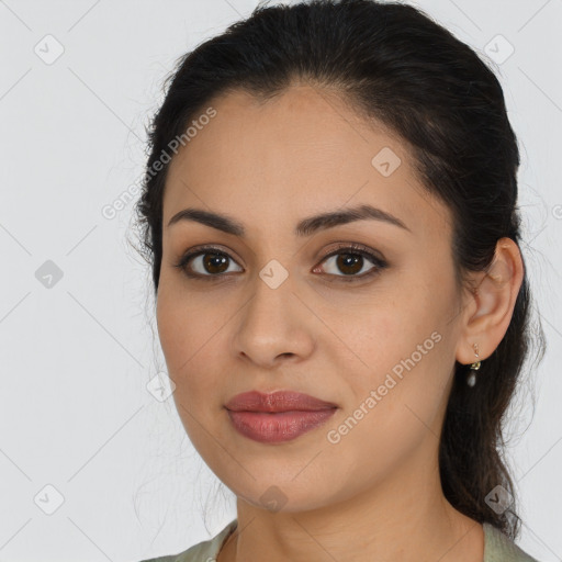 Joyful latino young-adult female with long  brown hair and brown eyes