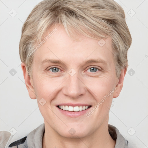 Joyful white adult female with short  brown hair and grey eyes