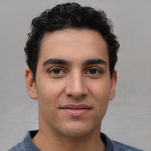 Joyful white young-adult male with short  black hair and brown eyes