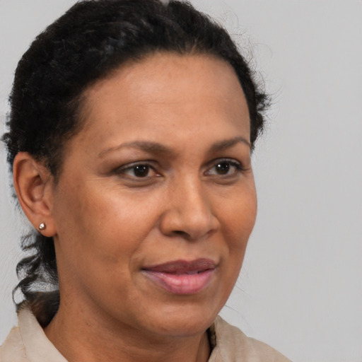 Joyful latino adult female with short  brown hair and brown eyes