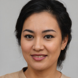 Joyful asian young-adult female with medium  brown hair and brown eyes