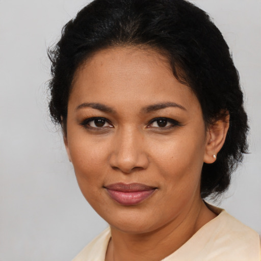 Joyful latino adult female with medium  brown hair and brown eyes