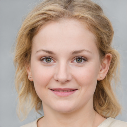 Joyful white young-adult female with medium  brown hair and blue eyes