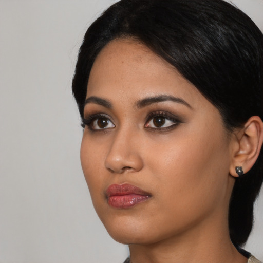 Neutral black young-adult female with medium  black hair and brown eyes