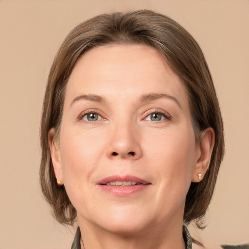 Joyful white adult female with medium  brown hair and grey eyes