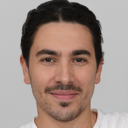 Joyful white young-adult male with short  black hair and brown eyes