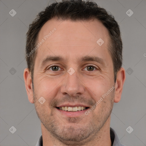 Joyful white adult male with short  brown hair and brown eyes