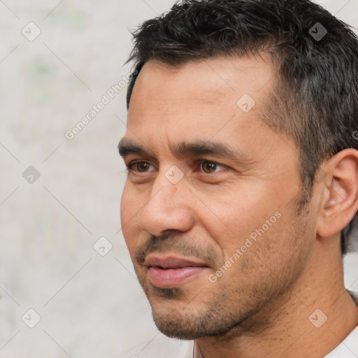 Joyful white adult male with short  black hair and brown eyes