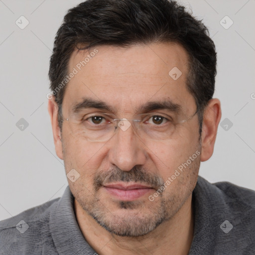 Joyful white adult male with short  black hair and brown eyes