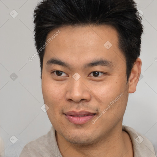 Joyful asian young-adult male with short  brown hair and brown eyes