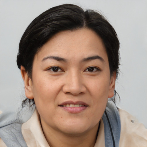 Joyful asian adult female with medium  brown hair and brown eyes