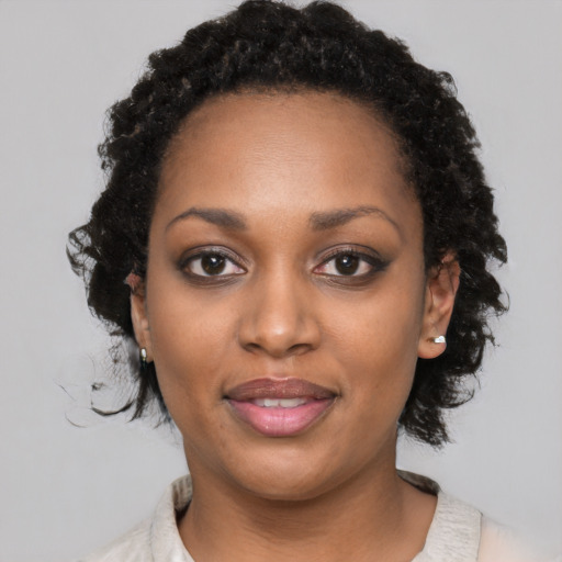 Joyful black young-adult female with medium  black hair and brown eyes