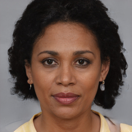Joyful black adult female with short  brown hair and brown eyes