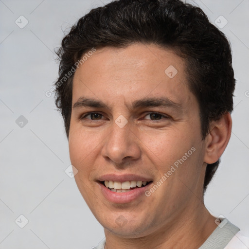 Joyful white adult male with short  brown hair and brown eyes