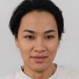 Joyful asian young-adult female with short  brown hair and brown eyes