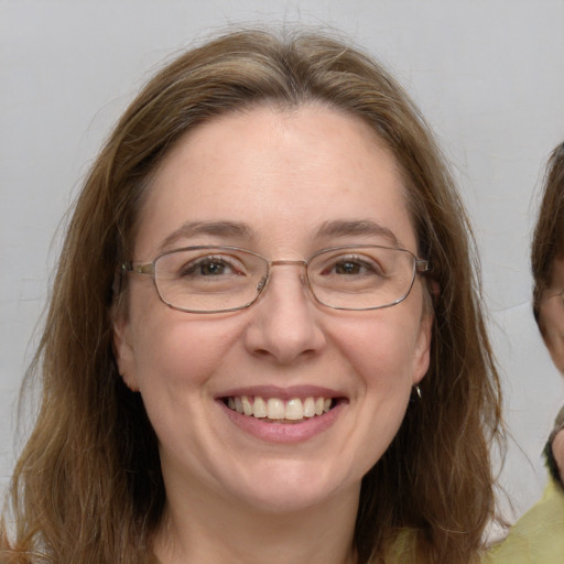 Joyful white adult female with medium  brown hair and grey eyes